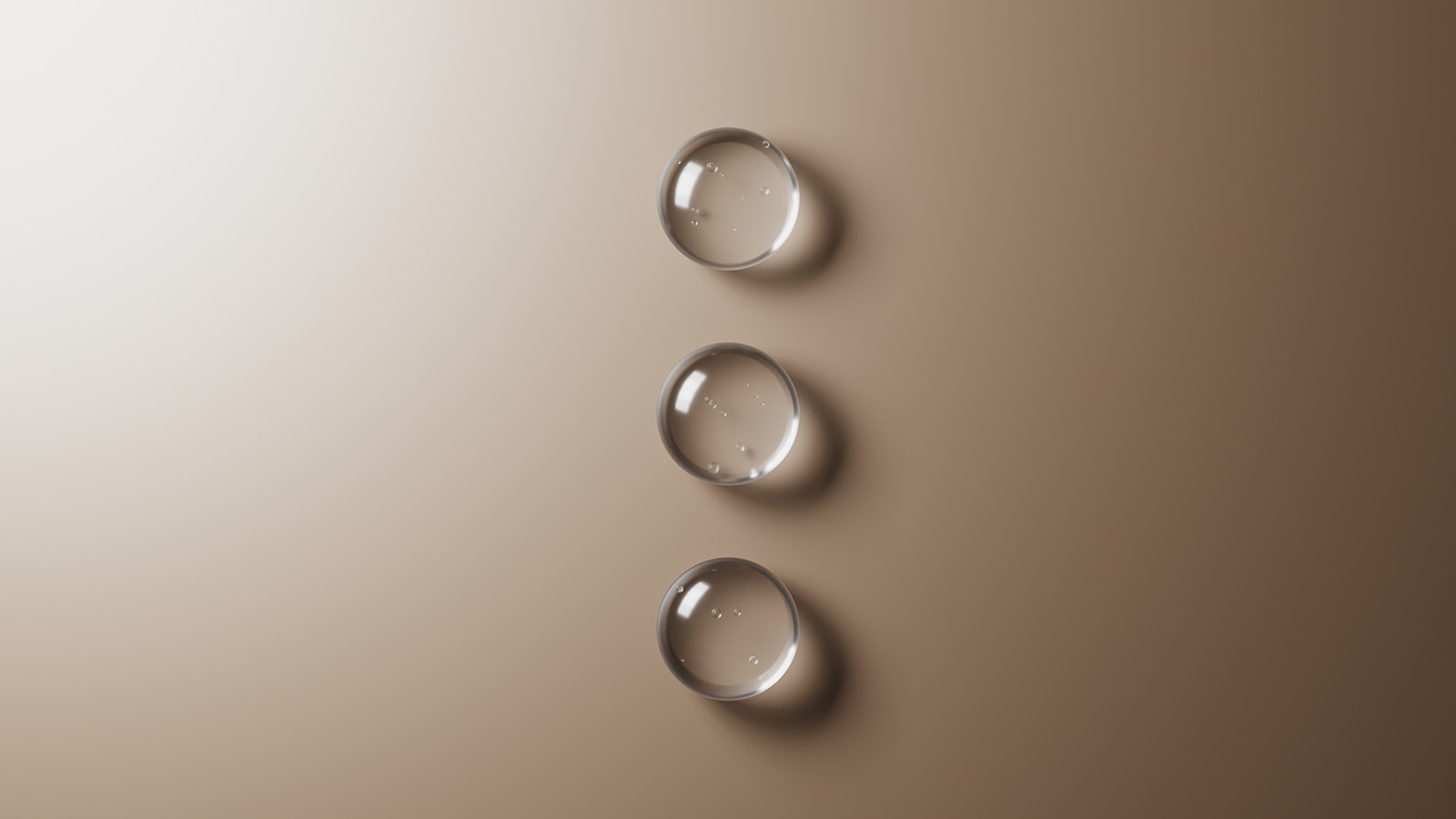 Three drops of water sitting on top of a table